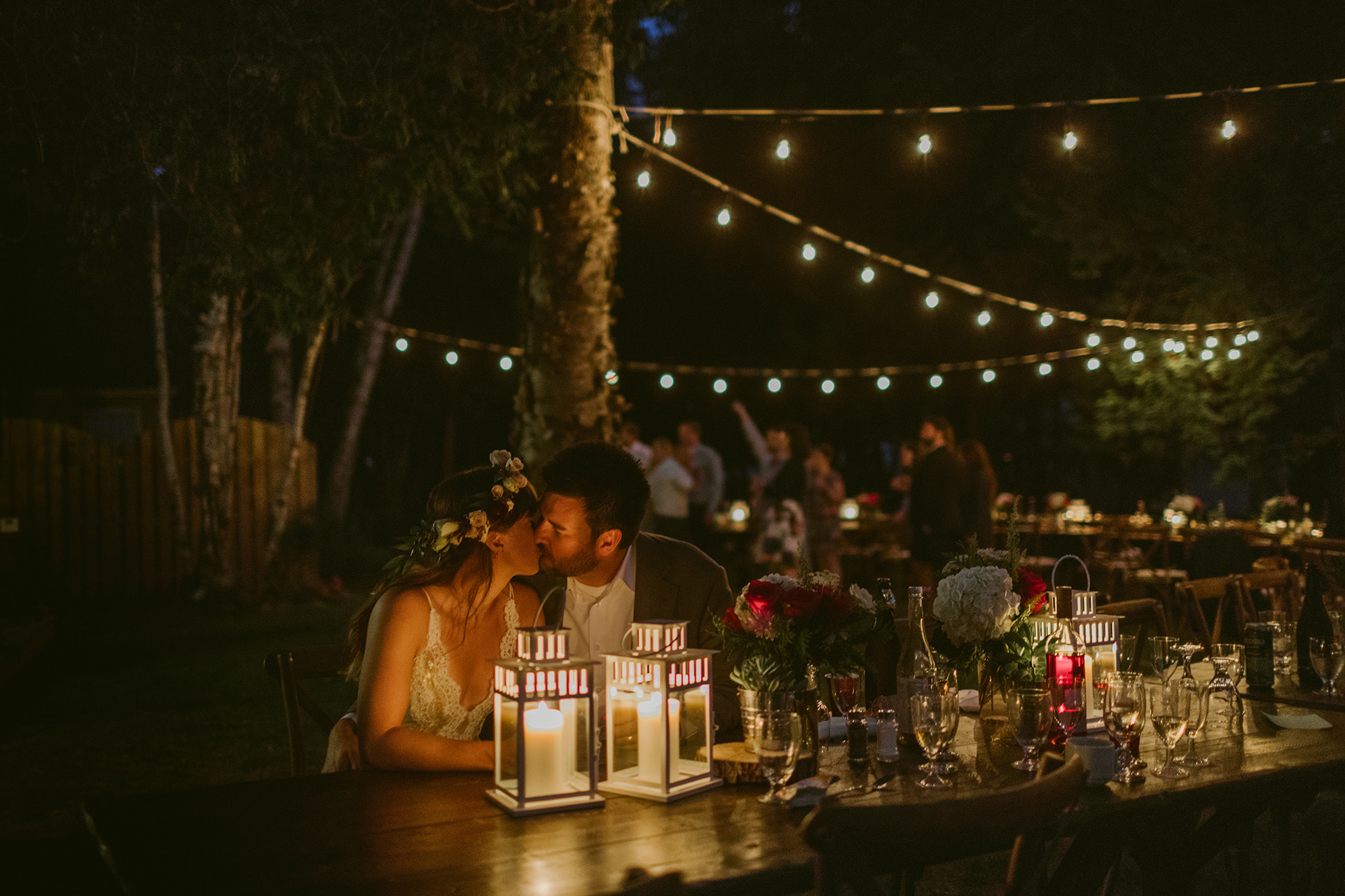 backyard candle light kissing wedding