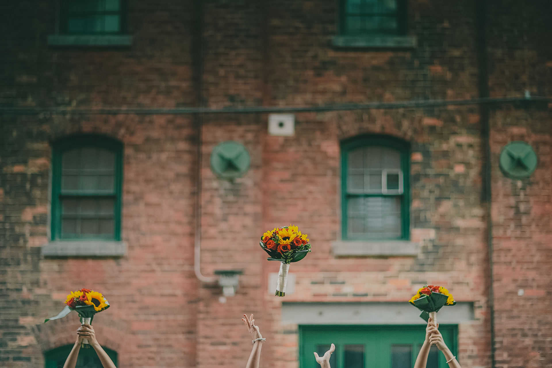 bride and bridesmaids flower bouquet toss at distillery district toronto